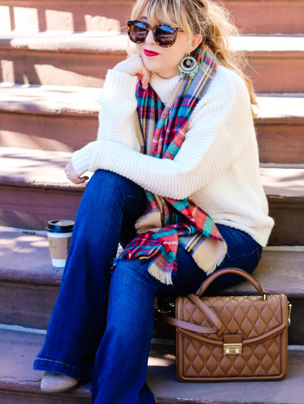 Fall outfit idea: turtleneck sweater, flare jeans and plaid blanket scarf