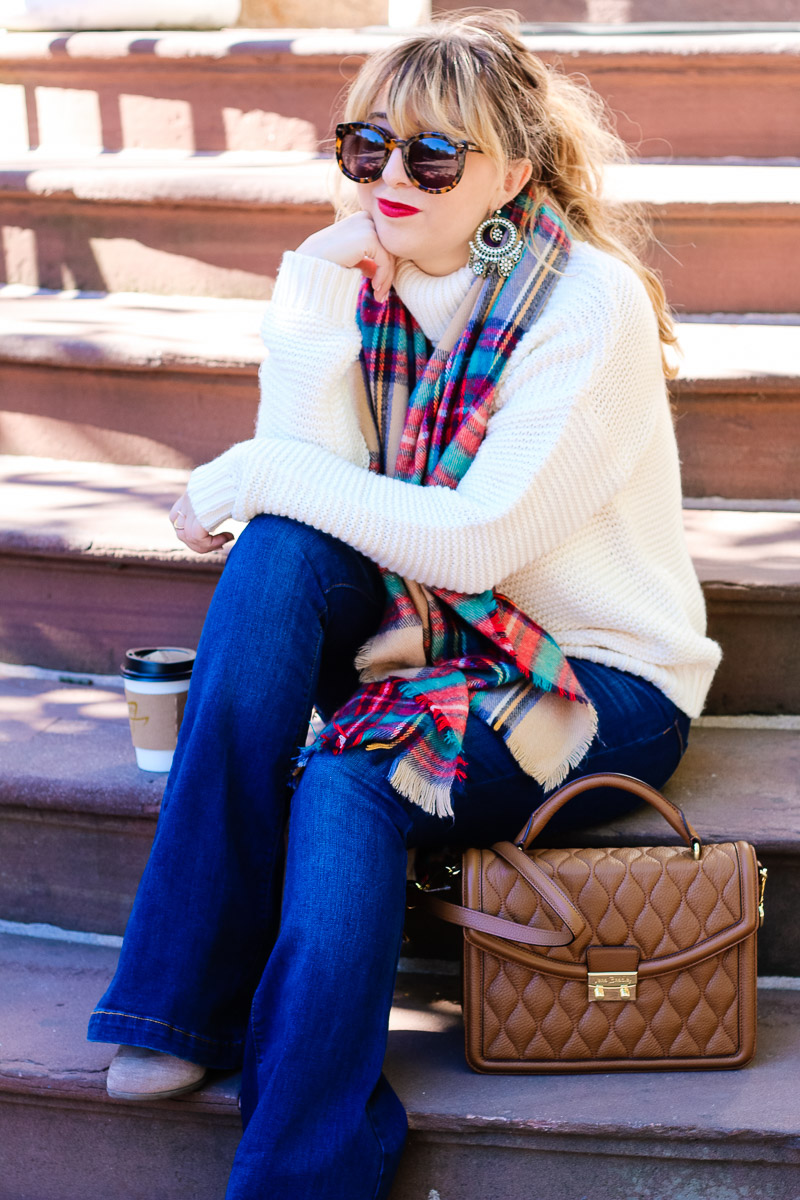 Fall outfit idea: turtleneck sweater, flare jeans and plaid blanket scarf