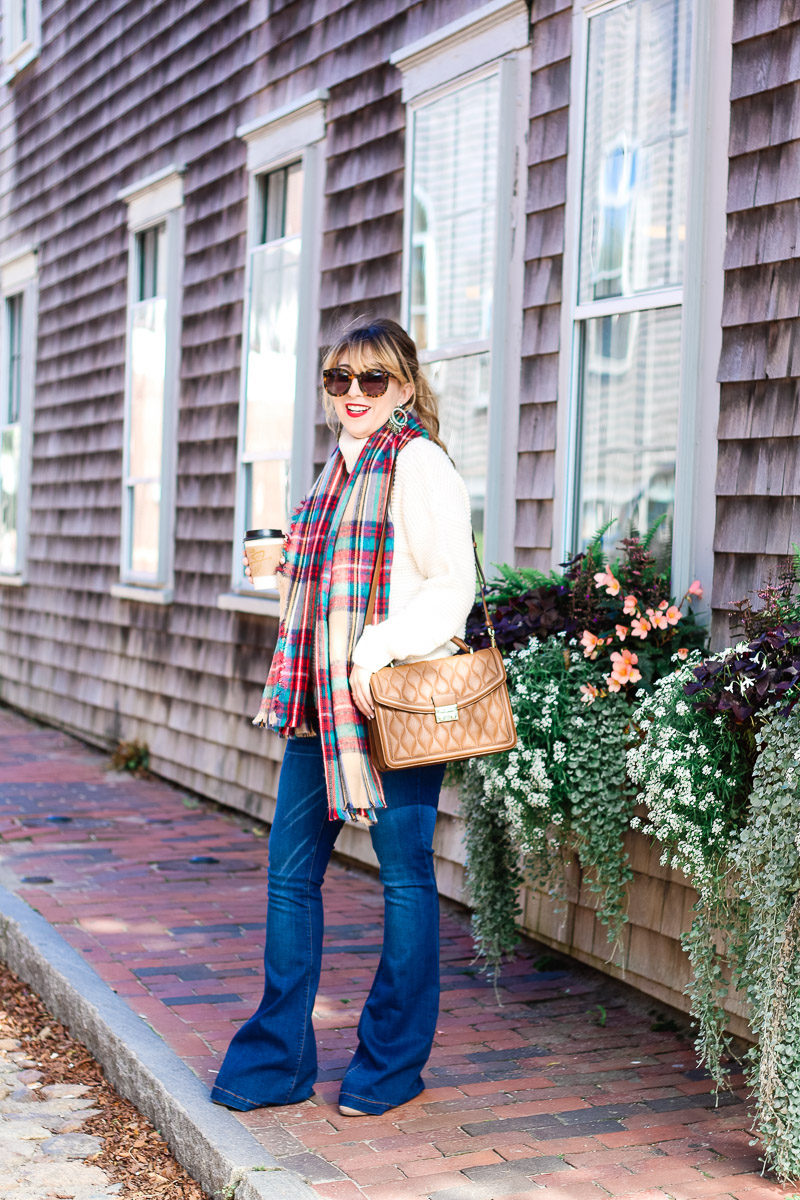 Miami fashion blogger Stephanie Pernas of A Sparkle Factor pairs a comfy turtleneck sweater with jeans and a plaid blanket scarf for a cute fall outfit idea