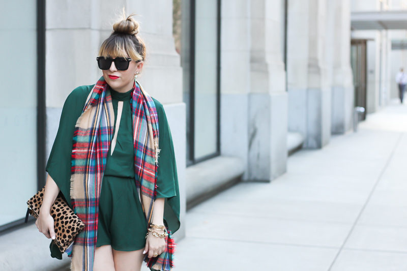 Miami fashion blogger Stephanie Pernas wears an emerald green Forever 21 romper with a plaid blanket scarf and over the knee boots. 