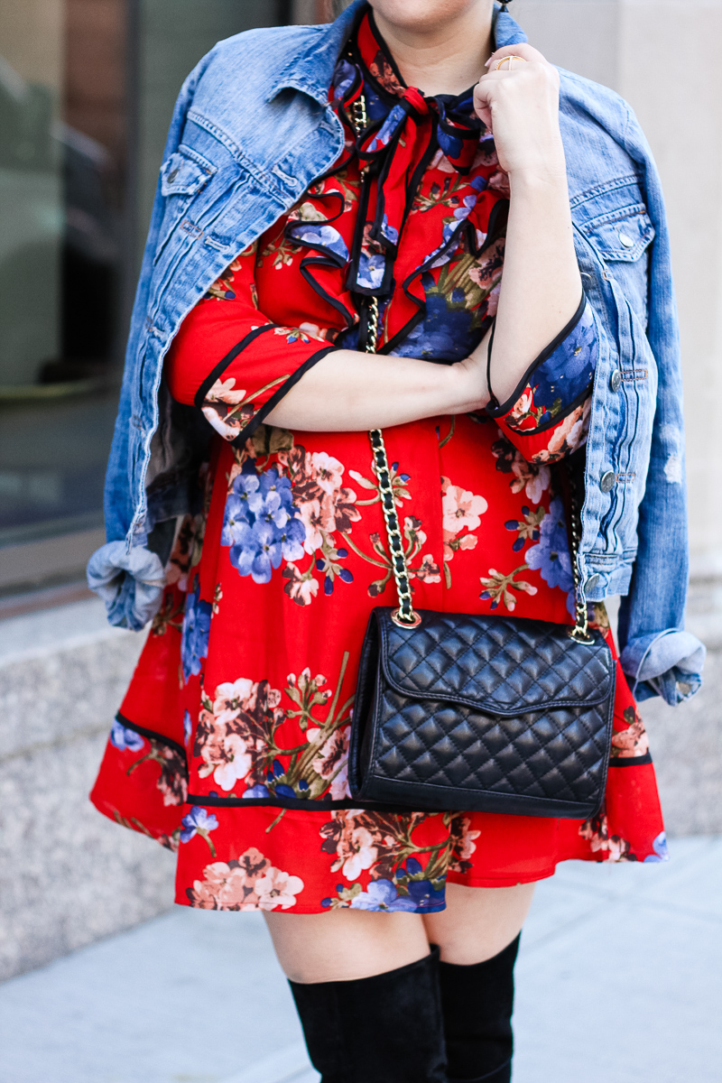 Miami fashion blogger Stephanie Pernas of A Sparkle Factor wearing a jean jacket draped over tie neck dress.