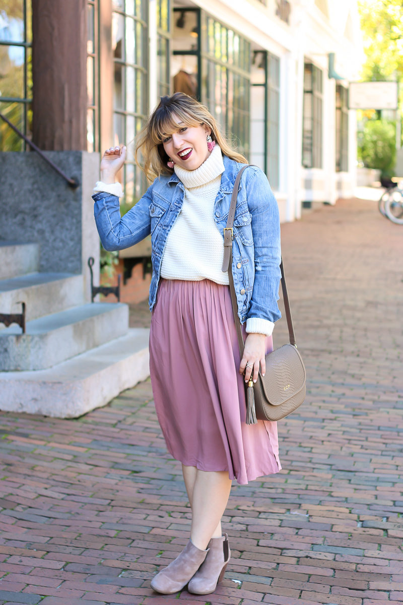 Miami fashion blogger Stephanie Pernas wearing a jean jacket with a turtleneck sweater and midi skirt.