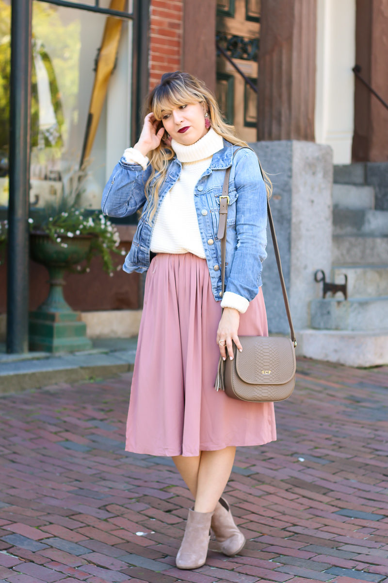 Miami fashion blogger Stephanie Pernas styles a midi skirt with a turtleneck sweater and booties for an easy fall outfit idea.