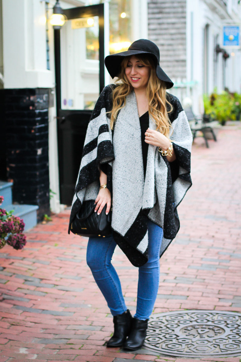 Miami fashion blogger Stephanie Pernas styles a cozy poncho with jeans and booties for an easy fall outfit idea.