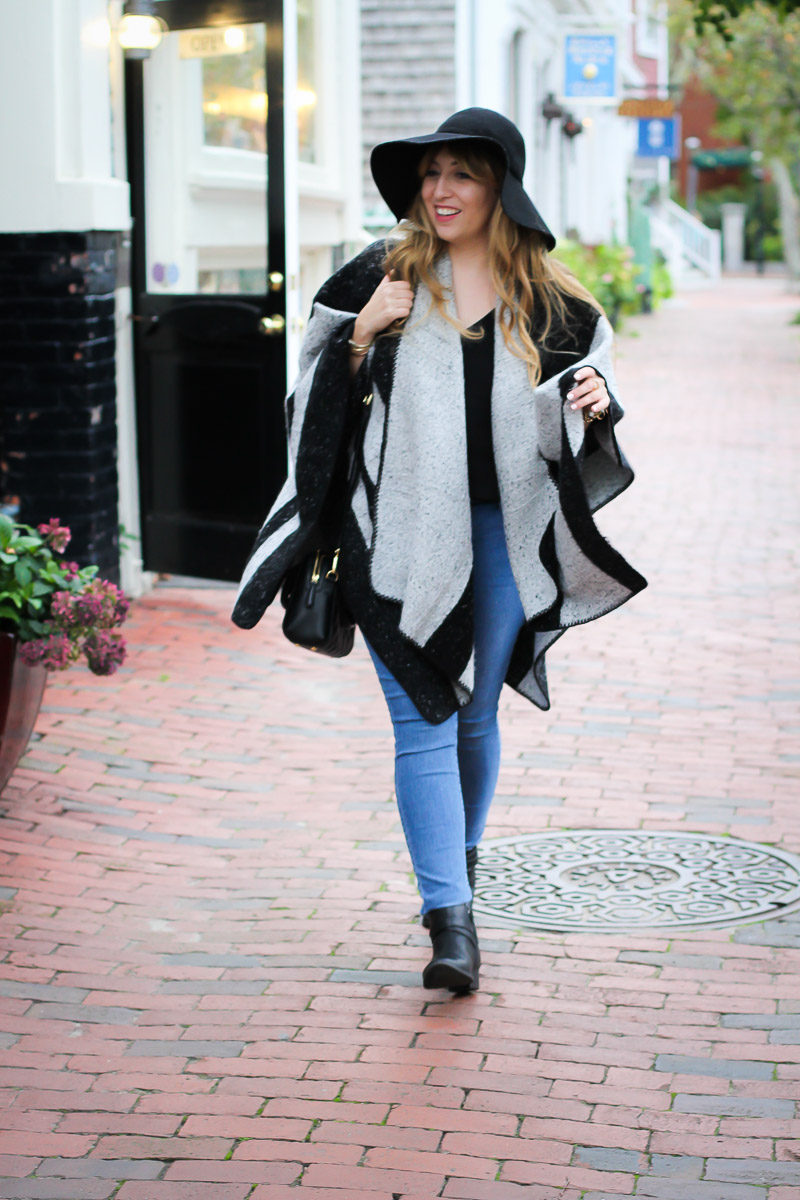 Miami fashion blogger Stephanie Pernas styles an easy fall outfit idea with a warm stripe cape and jeans. 