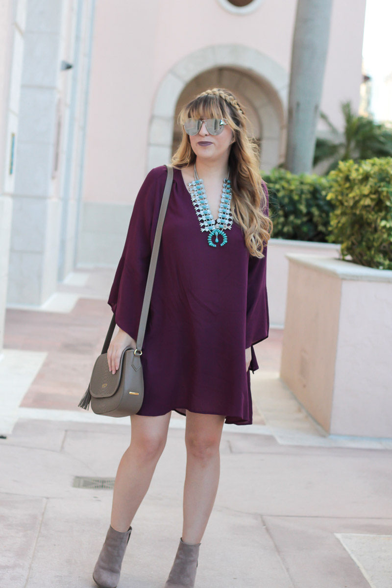 Miami fashion blogger Stephanie Pernas wearing a plum dress with turquoise statement necklace for a comfy Thanksgiving dress idea