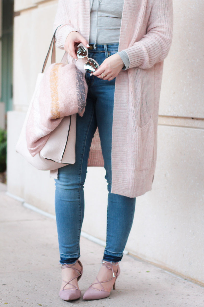 Miami fashion blogger Stephanie Pernas of A Sparkle Factor styles a blush blanket scarf with jeans and blush accessories