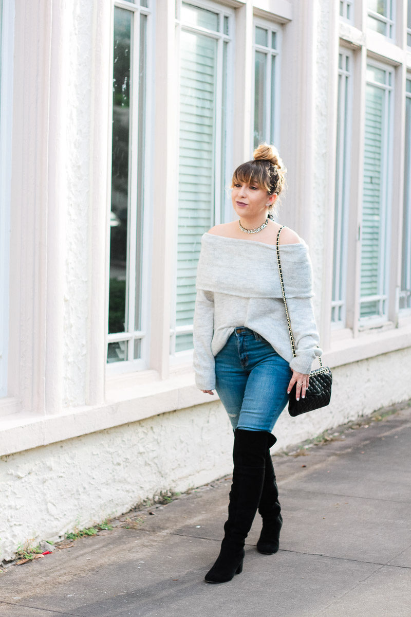 Miami fashion blogger Stephanie Pernas of A Sparkle Factor wearing an off the shoulder sweater, jeans, over the knee boots and a choker for a casual outfit idea