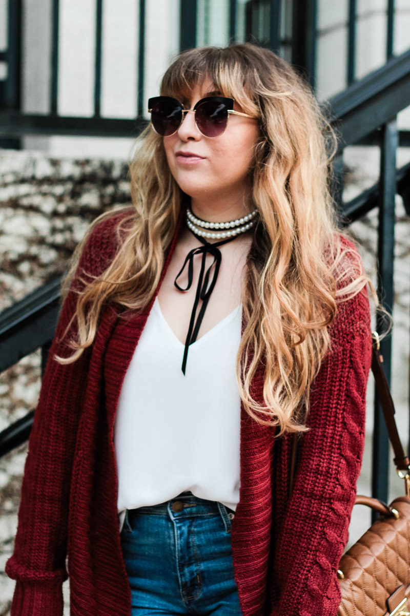 Miami fashion blogger Stephanie Pernas of A Sparkle Factor styles Baublebar Guinevere choker with a burgundy cable knit cardigan 