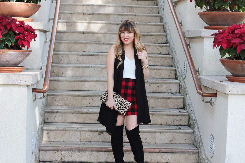 Miami fashion blogger Stephanie Pernas styles a buffalo plaid skirt outfit with Sole Society Leandra over the knee boots.