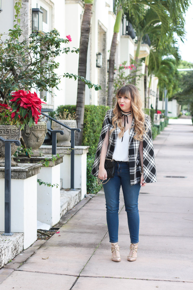 Miami fashion blogger Stephanie Pernas styles a Trina Turk plaid cape blazer with jeans for a classic casual look.