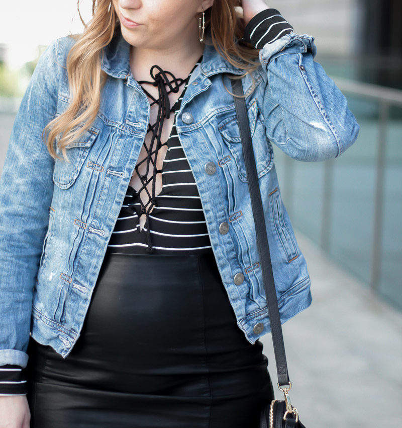 Miami fashion blogger Stephanie Pernas styles a lace up body suit with jean jacket for a cute leather skirt outfit idea