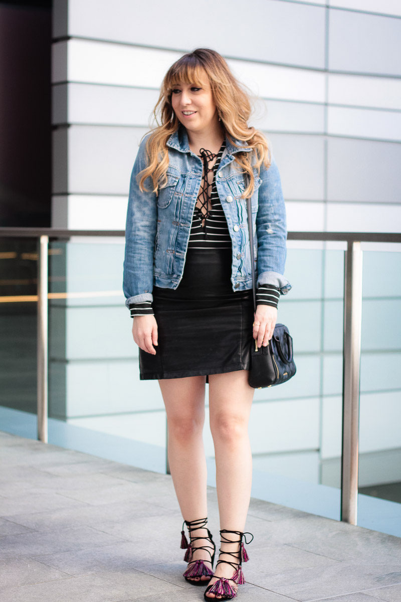 Miami fashion blogger Stephanie Pernas styles a striped lace up top with leather skirt and tassel sandals 