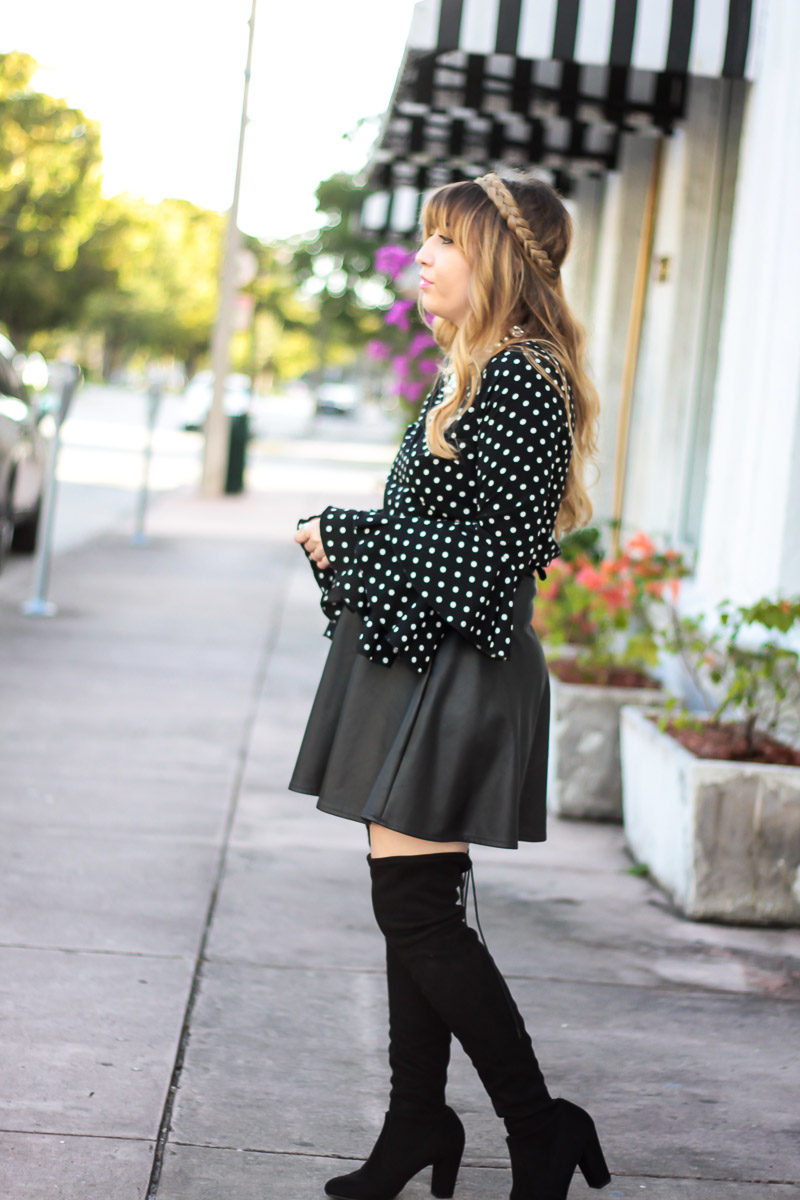 Fashion blogger Stephanie Pernas styles a polka dot blouse with leather skirt and over the knee boots