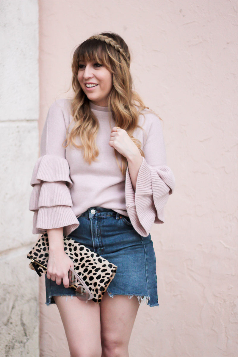 Miami fashion blogger Stephanie Pernas styles a jean skirt with a ruffle sleeve sweater for a girly outfit idea