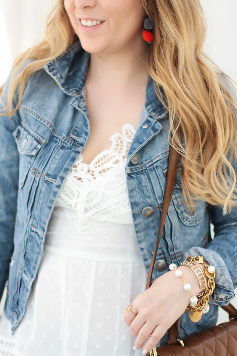 Miami fashion blogger Stephanie Pernas wearing a white lace dress with a jean jacket for a feminine spring outfit idea 