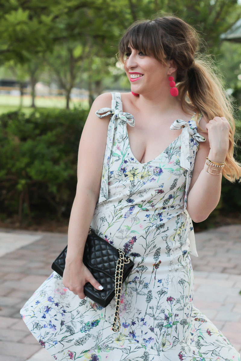 Miami fashion blogger Stephanie Pernas wearing a bow shoulder floral midi dress