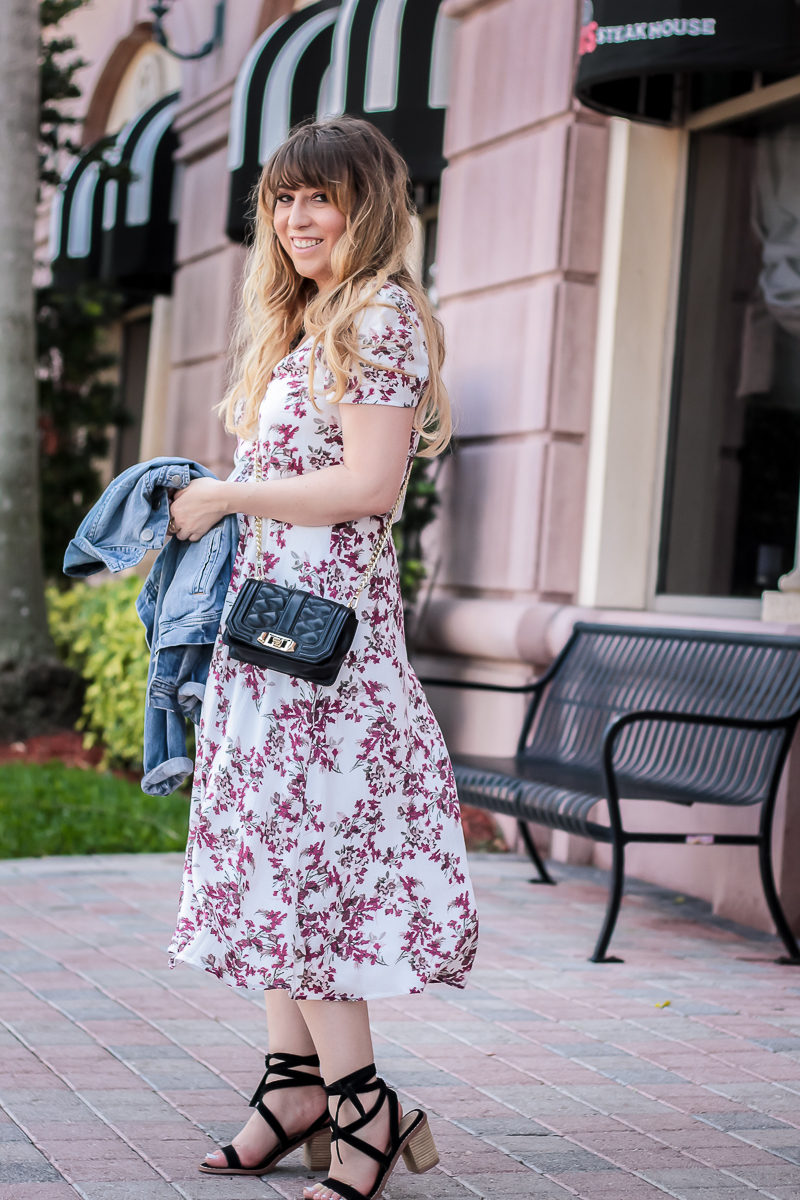 Miami fashion blogger Stephanie Pernas styles a floral midi dress and Rebecca Minkoff crossbody 