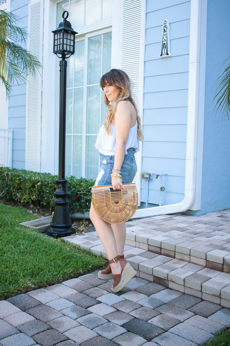 Miami fashion blogger Stephanie Pernas wearing a one shoulder top and statement earrings for spring 