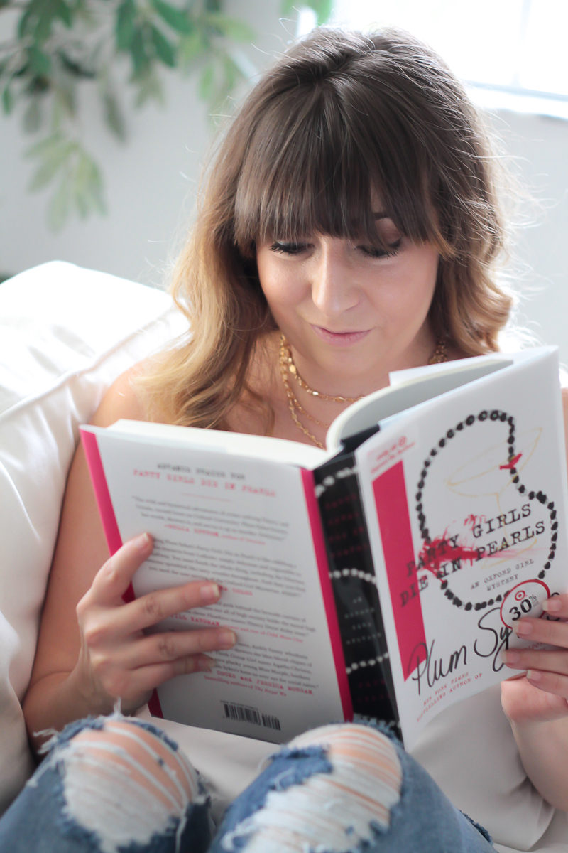 Miami fashion blogger Stephanie Pernas reading Party Girly Die in Pearls by Plum Sykes