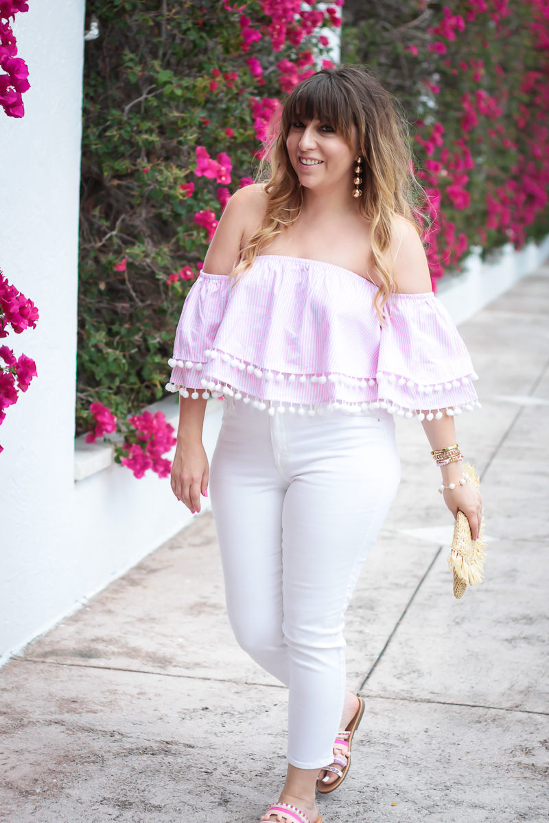 Miami fashion blogger Stephanie Pernas wearing an off the shoulder pom pom top and white jeans 