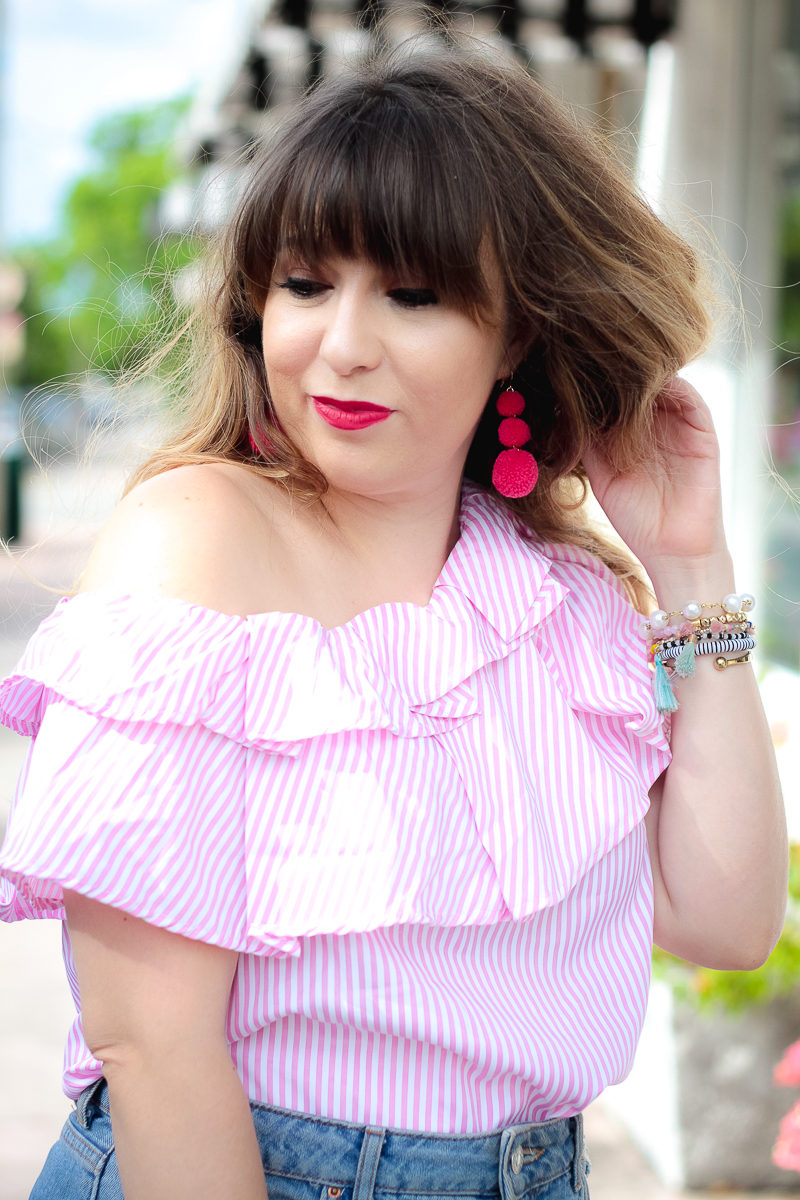 Miami fashion blogger Stephanie Pernas wearing Baublebar Crispin Pom earrings and a one shoulder top 