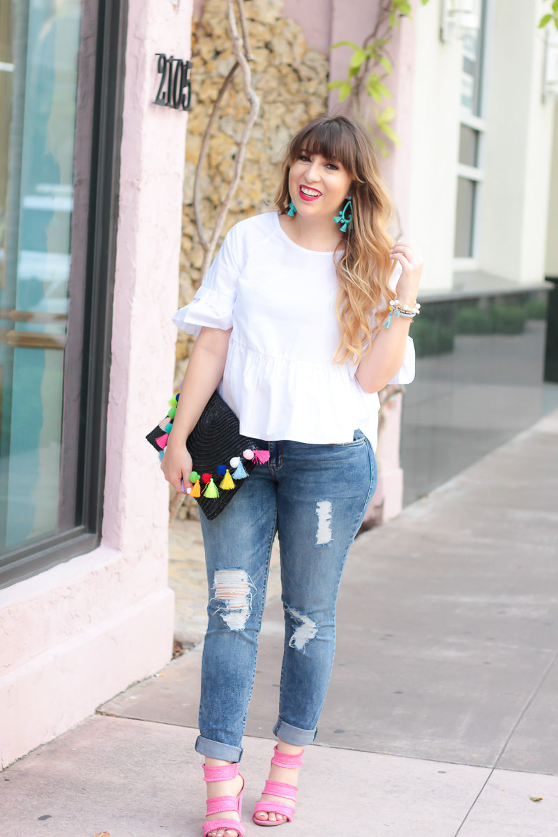 Miami fashion blogger Stephanie Pernas styles a white peplum top and jeans outfit for summer