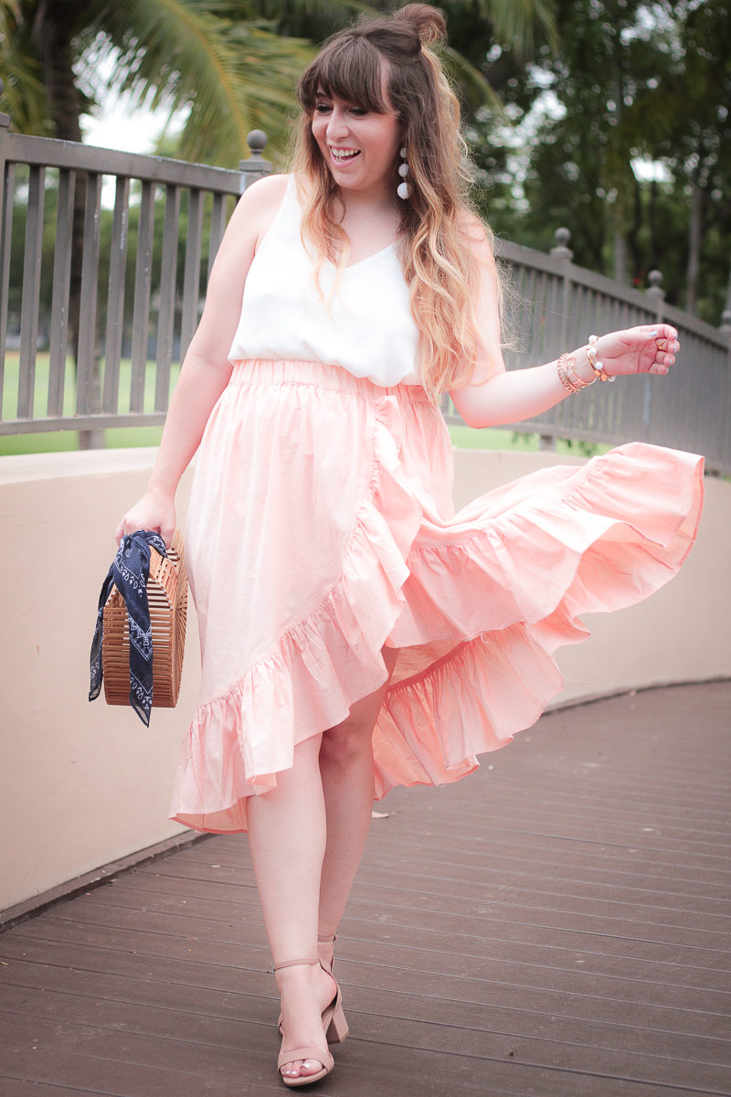 Fashion blogger Stephanie Pernas of A Sparkle Factor styles a pink wrap skirt and camisole 