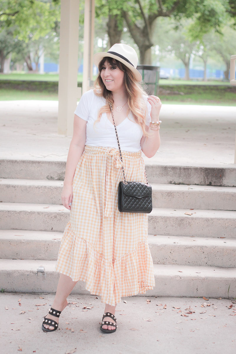 Miami fashion blogger Stephanie Pernas wearing a gingham skirt and pearl slide sandals 