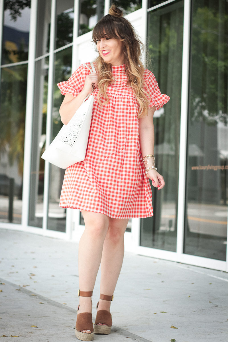 Miami fashion blogger Stephanie Pernas styles a red gingham babydoll dress for a cute July 4th outfit idea 