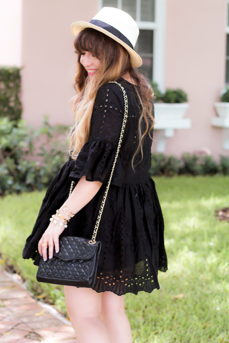 Miami fashion blogger Stephanie Pernas wearing a Shein black eyelet babydoll dress and J.Crew Panama hat